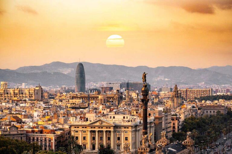 Panoramic view of Barcelona from Park Güell with colorful mosaic benches and cityscape in the background